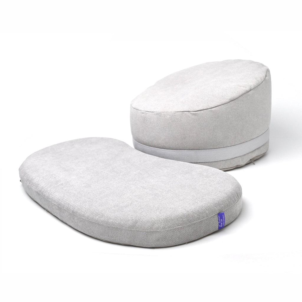 Light gray round meditation cushion and rectangular floor cushion on a white background.